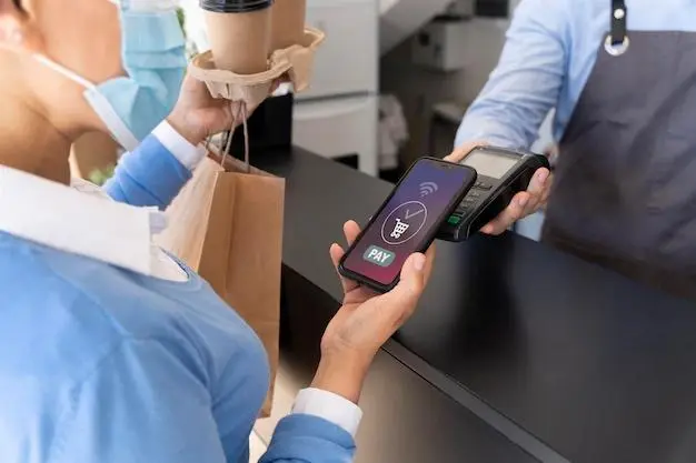 Customer using the mobile payment option to pay the bills in a supermarket